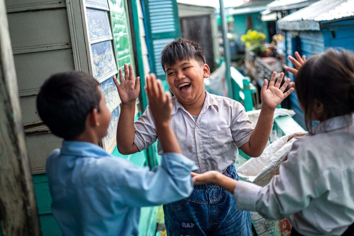 CH1732696_Children playing outside their school on Tonle Sap Lake, Cambodia.-1